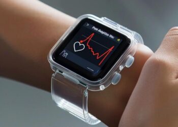 In the photo, a person is seen wearing a smartwatch with a clear protective case. The watch's screen shows a live heart rate monitor graph, indicating that the user is tracking their pulse in real time. It's a glimpse into the integration of technology in our daily lives, showcasing how wearable devices can help us keep an eye on our health metrics. This smart accessory serves not only as a piece of technology but also as a fashion statement and a fitness companion.